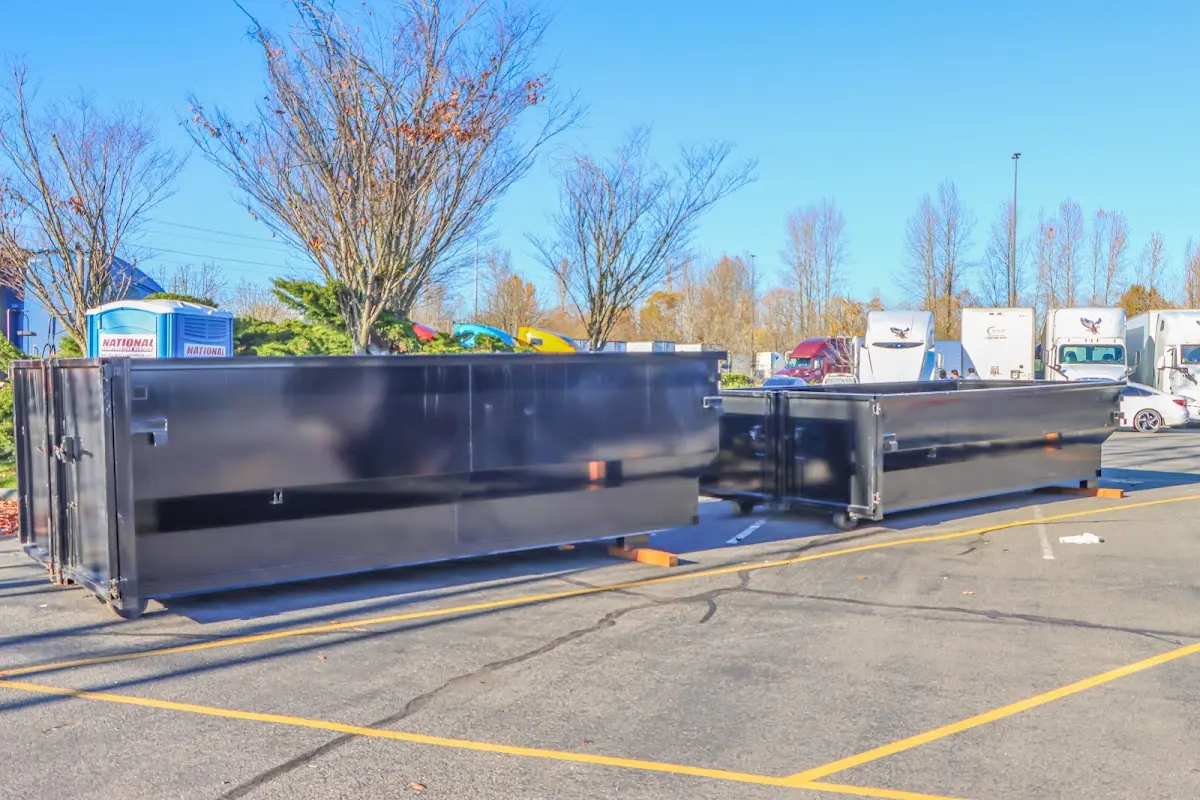 Professional dumpster rental service with roll-off container on residential driveway in Ridgewood village